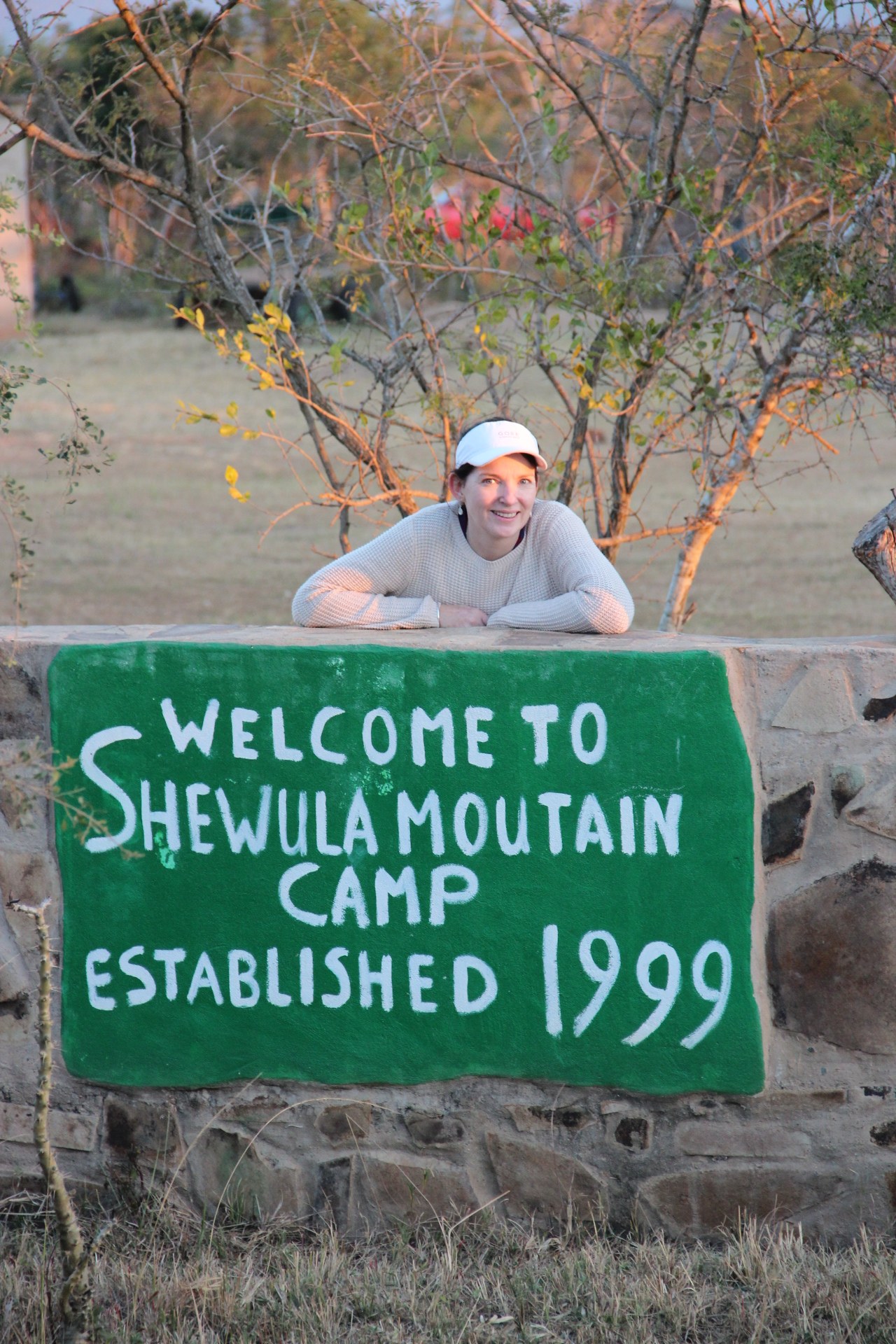 Cathy at the Shewula Mountain Camp sign, Swaziland